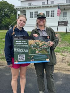 Girl scout holds up the project she's worked on for Gold Award.